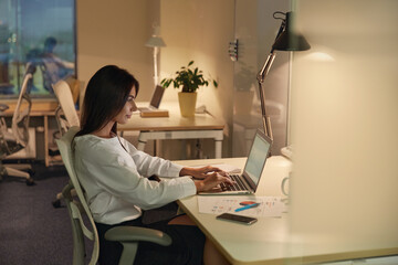 European businesswoman working on laptop in office