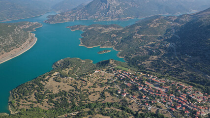 Aerial drone photo of small picturesque village of Lidoriki built near lake and dam of Mornos a clean water supply for Attica, Greece