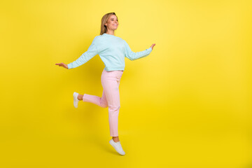 Fototapeta na wymiar Full length body size view of pretty cheerful girl jumping going good mood copy space isolated over bright yellow color background
