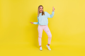 Fototapeta na wymiar Full length body size view of attractive funky cheerful girl showing v-sign having fun isolated over bright yellow color background
