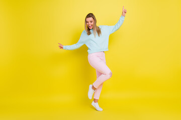 Fototapeta na wymiar Full length body size view of pretty nice cheery girl dancing having fun isolated over bright yellow color background
