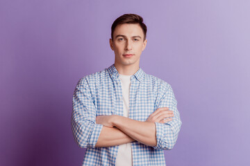 Portrait of confident self-assured businessman guy crossed hands on purple background