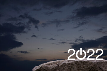 2022 start up business flat icon on rock mountain over sunset sky, Happy new year 2022 cover concept