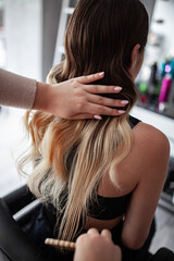 stylist hairdresser makes a hairstyle for a girl in his beauty salon, hollywood wave, beautiful hairstyle, hairdresser at work