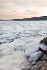 Beautiful winter landscape of Baikal Lake in December morning. Freeze-up in the Olkhon Gate Strait,...
