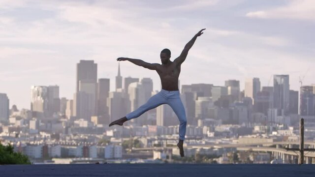 Graceful ballet dancer jumping and twirling in the air. San Francisco