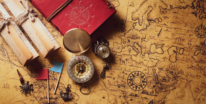 Happy Columbus Day concept. Vintage compass and treasure manuscript.  Flat lay, top view with copy space.
