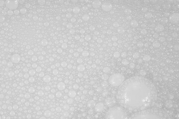 Obraz premium Texture of small soap bubbles on water background. foam