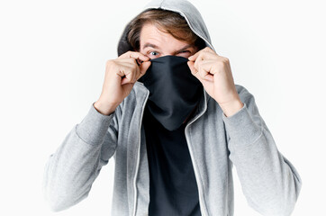 man hiding his face under a mask with a hood anonymity crime theft close-up