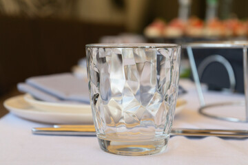 glasses on the table in a restaurant with food and serving