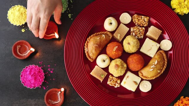 Indian woman serve Diwali sweets Gujiya peda barfi Indian Sweet dessert mithai festival Dussehra Holi ganesh chaturthi Ram navami Durga pooja ashtami Navratri 4K footage Mumbai Kerala India Sri Lanka