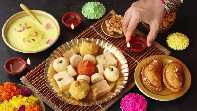 Indian woman serve Diwali sweets Gujiya peda barfi Indian Sweet dessert mithai 4K footage festival      dish Dussehra Holi ganesh chaturthi Ram navami Durga pooja durga ashtami Navratri Mumbai India 