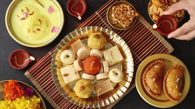 Indian woman serve Diwali sweets Gujiya peda barfi Indian Sweet dessert mithai festival dish Dussehra Holi ganesh chaturthi Ram navami Durga pooja, durga ashtami Navratri Mumbai Kerala India Sri Lanka