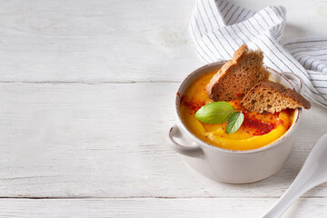 Pumpkin vegetable puree in a plate, copy space
