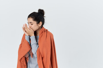 sick woman covered herself with a blanket runny nose health problems