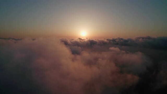 Fly through the clouds during sunrise.