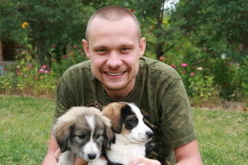 man with puppies