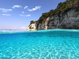 Underwater sea level split photo of beautiful paradise turquoise exotic island beach in Caribbean island destination