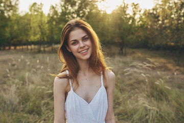 Woman in white dress nature field walk vacation