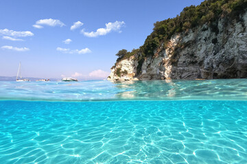 Obraz premium Underwater sea level split photo of beautiful paradise turquoise exotic beach of Voutoumi probably the best in Greece, Ionian island of Antipaxos