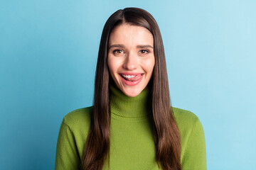 Portrait of attractive cheerful girl licking lip starving good mood isolated over bright blue color background