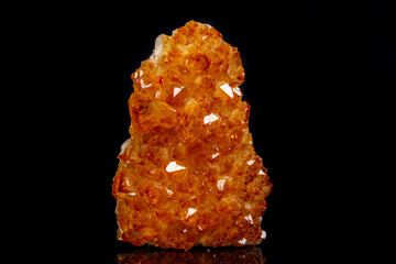 Macro mineral stone Citrine in rock in crystals on a black background