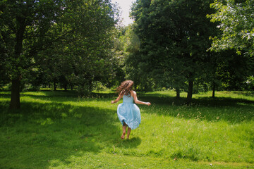 girl running away barefoot in the park