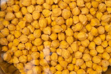 Chickpeas in a bowl are soaked in water