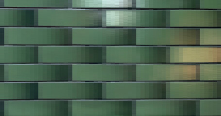 Błyszczące płytki ceramiczne z zielonym gradientem na których połyskują dwa bliki