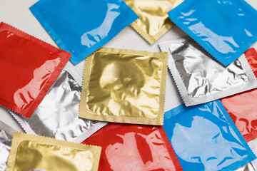 Colorful lot of condom put on the table. Campaign for safe sex and contraception.