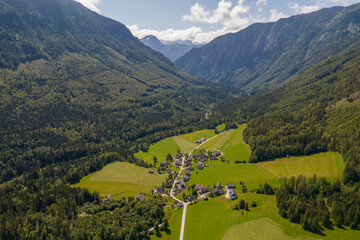 Aerial view of the village, fields and forest in mountains Alps Austria