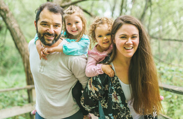 nice family having fun in summer forest