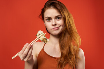 cute red-haired woman chopsticks rolls and seafood snack