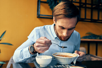 Man eating soup lunch snack in a restaurant