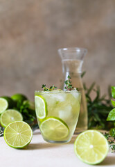 Refreshment infused water with lime and thyme. Healthy drink and detox concept.