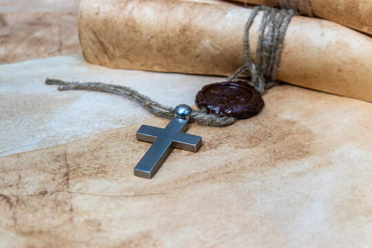 Cross and medieval scrolls.