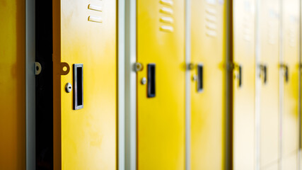 Row of yellow metal lockers in locker room