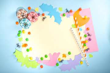 Bright color mockup party invitation, menu, greeting card for Halloween holiday. Trendy colorful background with paper Halloween symbols ghost, bats, sweets, cocktail tubes. Top view frame copy space