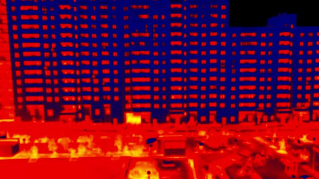 . Blurred unrecognizable people. Urban dynamics, the movement of people and cars in the courtyard of a huge apartment building (Santa's workshop, rat race). Illustration of thermal image timelapse