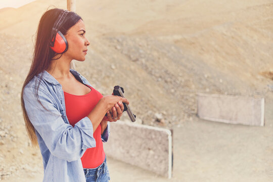 Woman releasing stress, Instructor helping woman with gun