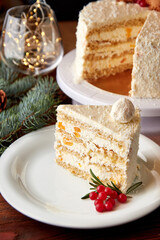 Slice of cake with coconut and peaches decorated for Christmas.