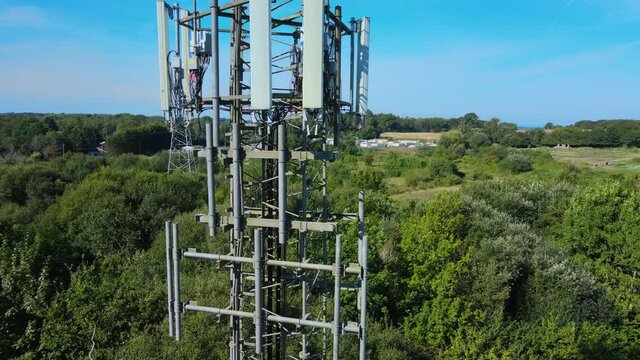 Aerial shot of 5G mast detail as drone circles around it