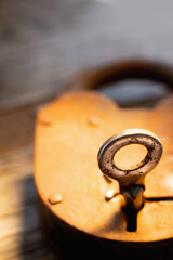 Antique rusty key in the lock. Vertical image. Copy space.