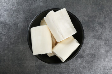 Cassava pieces isolated on dark background.
