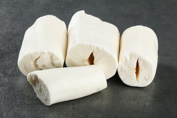 Cassava pieces isolated on dark background.