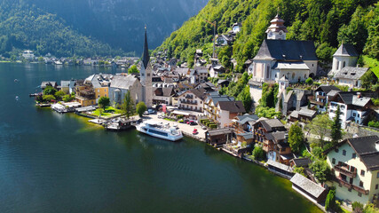 Fototapeta na wymiar Hallstatt, Austria. Aerial view of the beautiful town from a flying drone over the lake in summer season.