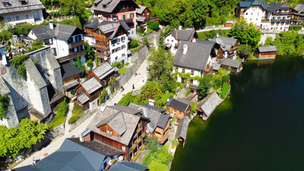 Naklejka premium Hallstatt, Austria. Aerial view of the beautiful town from a flying drone over the lake in summer season.