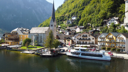 Obraz premium Hallstatt, Austria. Aerial view of the beautiful town from a flying drone over the lake in summer season.