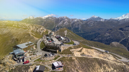 Fototapeta premium Amazing aerial view of Grossglockner mountain peaks covered by snow in summer season. Drone viewpoint over Edelweiss Spitze.