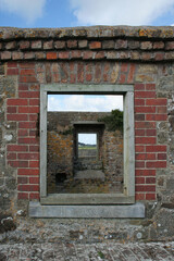 Fototapeta na wymiar window through the window. Geometric games in an abandoned red brick house, Cork, Ireland
